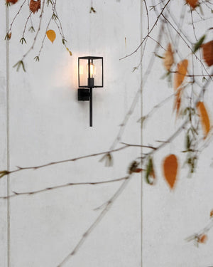 Modern Exterior Lantern Wall Light Installed on an exterior wall  near autum leaves| Lighting Collective