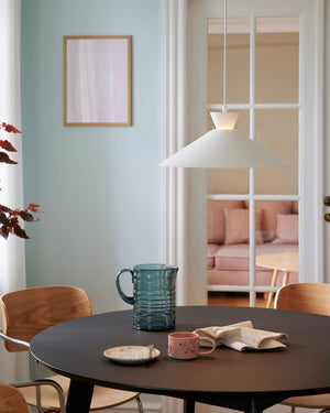 Nordic White Pendant suspended in Dining area above a round table. 