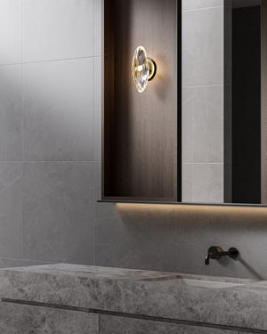 Bathroom interior with a wall-mounted light fixture and marble countertop.