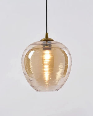 Clear glass pendant light with gold interior on a white background