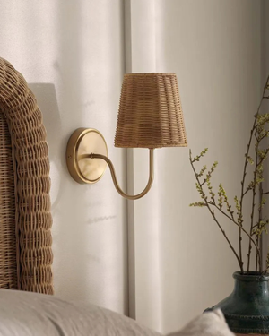 Wicker wall lamp with a brown shade on a neutral wall | Lighting Collective