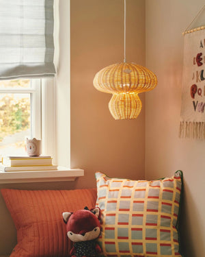 Rattan Mushroom Pendant hanging in the corner of a kids room - Lighting Collective 