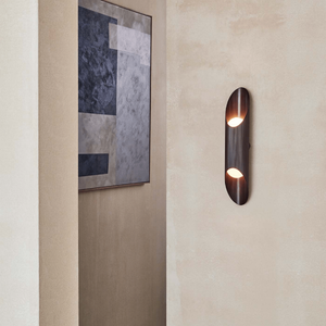 Reeded Brass Up and Down Wall Light | Lighting Collective | bronze in a corridor 