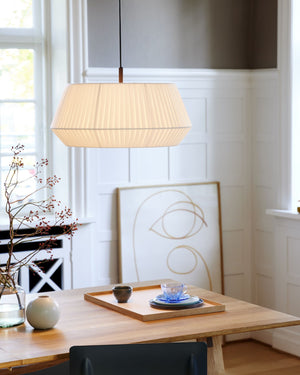 Scandinavian Pleated Pendant Light  in Beige suspended above a contemporary table - Lighting Collective  