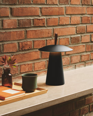 Black lamp on a stone surface with a brick wall background