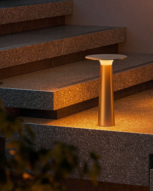 Gold outdoor lamps on stone steps with warm glow