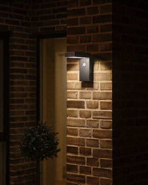 Solar Black Angled Wall Light on Brick Wall by Entrance Way - Lighting Collective 