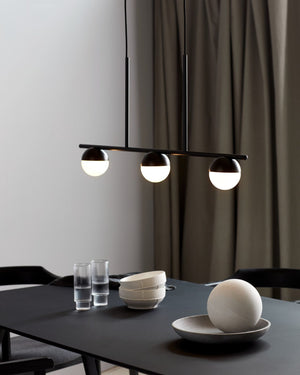 Black Trio Circular Horizontal Pendant Light over a dining table with minimal decor - Lighting Collective 