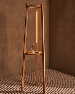 Tripod Timber Floor Lamp | Boyds with a warm glow against a brown wall Victorian ash