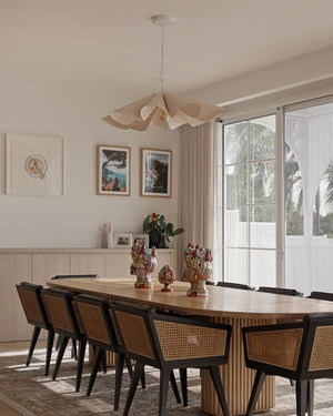 Modern interior dining room, featuring a wooden pendant.