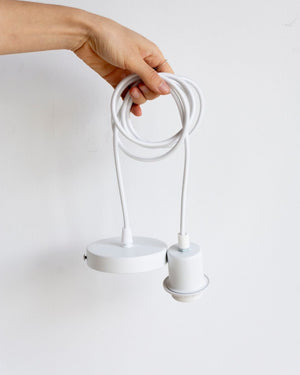 White suspension kit being held against white wall