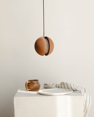 Cast Earth Downwards Spherical Pendant | Nongzao | Styled in a Warm Living Room
