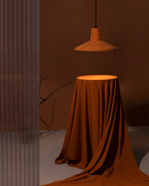 Earth Orange L Pendant Light hanging above table