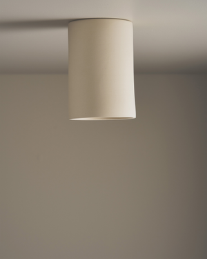 Long cream ceiling light fixture on a plain wall

