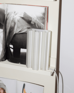 A modern translucent white ribbed pla plug in wall light by Franca Studio