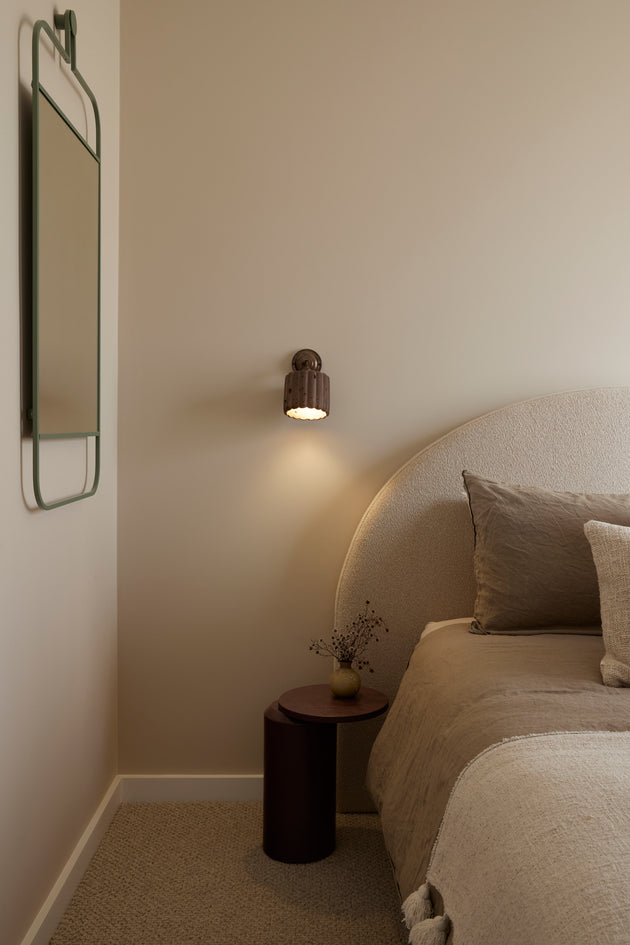 Concrete wall sconce made in Byron Bay in a soft minimalist bedroom 