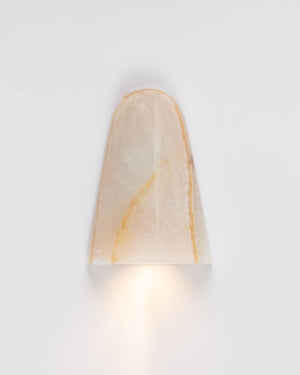 Wall-mounted light fixture with a beige shade on a white background