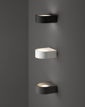 Curved outdoor up down wall lights in anthracite and white mounted on grey exterior corner wall