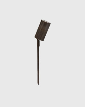 Slimline garden spike in antique  brass finish on grey background