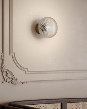 Designer Perfume Bottle Inspired Glass Wall Light above a couch in a retro style interior