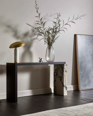White marble base with metal matte shade table lamp tilted on a table in living room