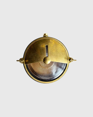 Brass bunker light on grey background
