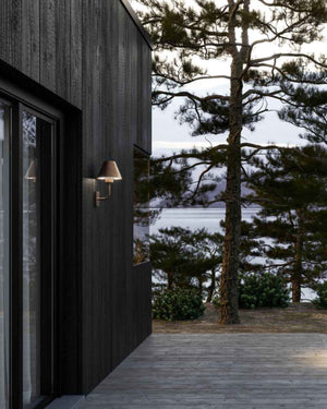 Exterior Shaded Italian Wall Light Near a door entrance of a house by a lake