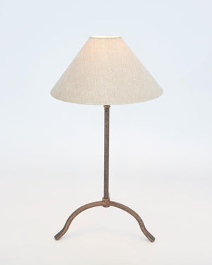 Farmhouse bronze table lamp with warm lighting against a white studio background