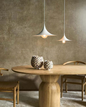 White curved conical pendant light suspended above wooden dining table in contemporary interior