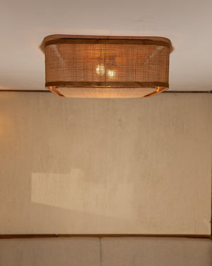 A square flush-mount natural bagor ceiling light mounted above a white ceiling