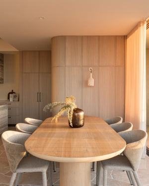 A warm modern dining room featuring a fossil coral wall light