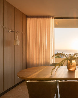 Modern dining room with a mounted a dome coral wall sconce
