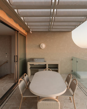 Outdoor dining area featuring a fossil wall sconce