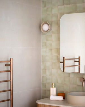 Ceramic dome wall sconce in a modern bathroom
