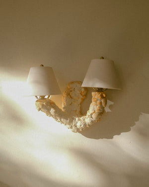 Shell textured wall light with two lampshades on white wall light off