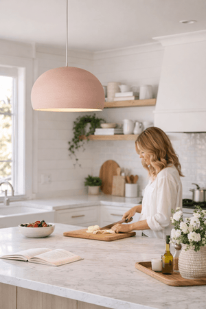 Handmade Spanish Clay Pendant Moon pendant in Piglet hanging in a modern kitchen with a woman cooking 