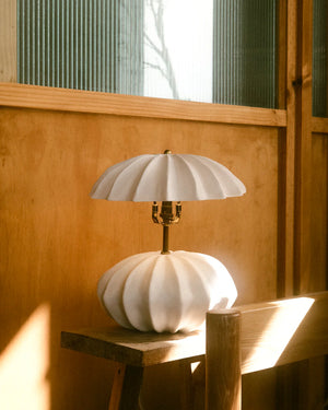 White textured ceramic table lamp on wooden table