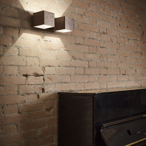 Modern Cube Brass and Plaster Wall Light bronze finish on a brick wall near a piano