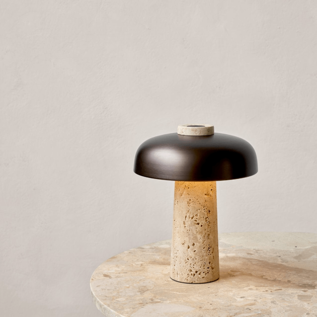 Curved Aluminium and Travertine Table Lamp | Reverse lit up on a marble table