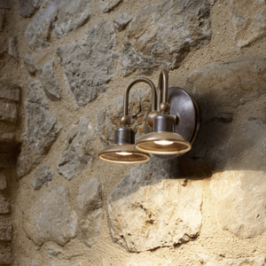 Aged Brass Curved Arm Double Wall Light Square on a brick wall