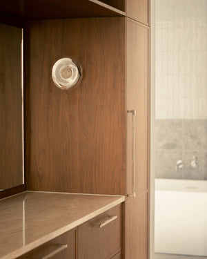 Glass dome wall light styled in a warm styled space