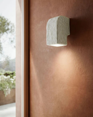 Italian Ceramic Down Wall Light mounted on terracotta wall casting warm downward wash of light in earthy interior