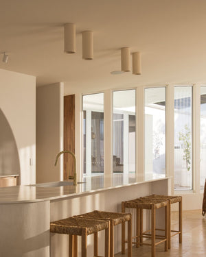Cylindrical ceiling lights installed above a kitchen bench