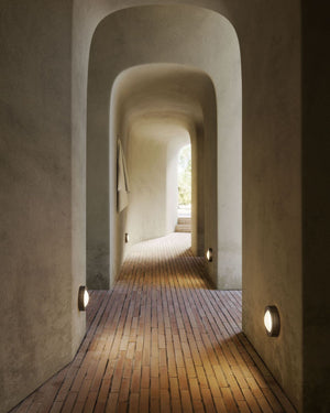 Aged Brass Italian Wall Lights with plain design placed at the bottom of the walls in a corridor