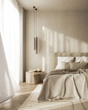 Ceramic & Brass Pendant Lights small and large sizes over a bedside table in a coastal bedroom