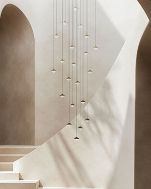 Constellation of brass pendants in a stairwell