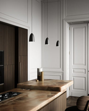 Modern kitchen with wooden countertops and pendant lights.