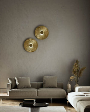 Pleated Brass Wall Lights decorating a minimalist living room over a sofa