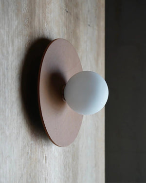 Leather wall light on a wooden wall