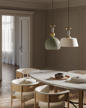 matte round green pendant together with a white pendant over a dining table